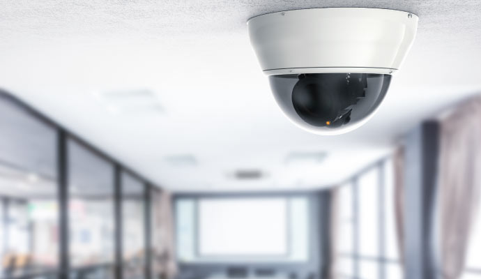 A dome security camera is installed on the ceiling