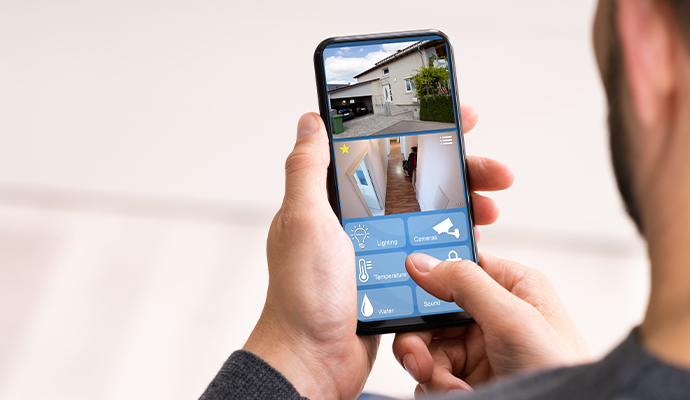 a man using smartphone to monitor his house