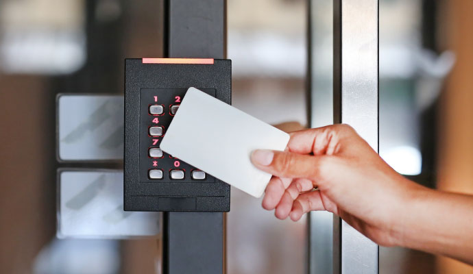 a person is swiping a card on a access control system on the door